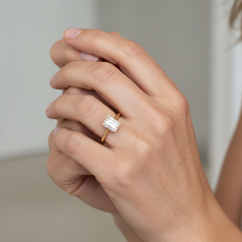 1 carat emerald cut solitaire ring in Gold claw set