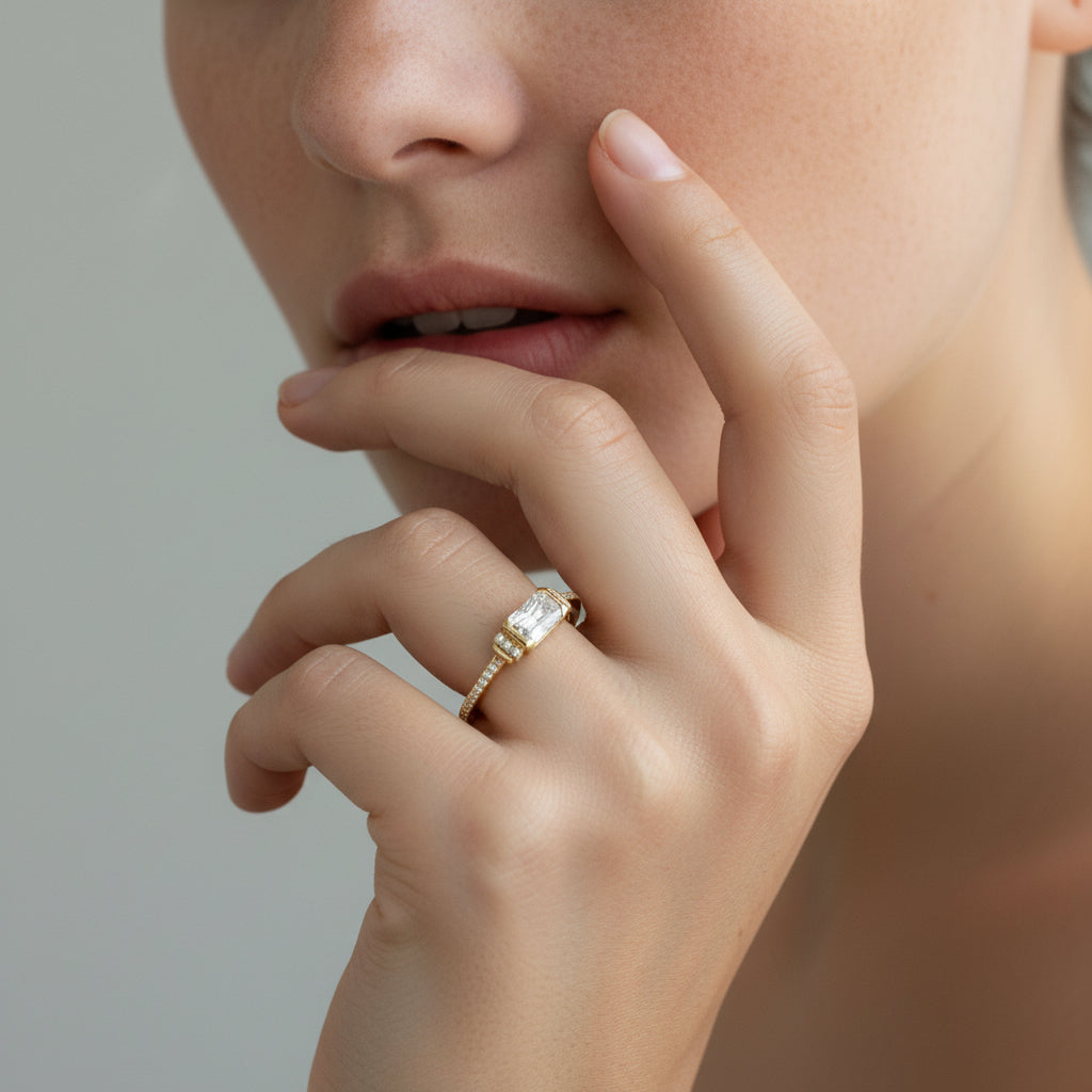 Emerald cut semi-rubover solitaire ring in gold
