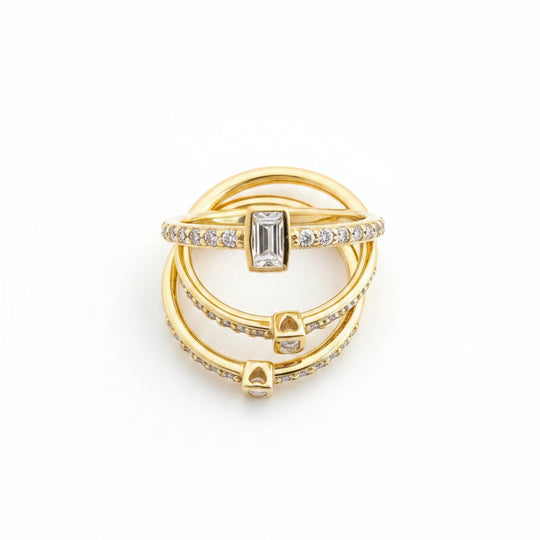 Emerald cut solitaire bezel set rings in gold