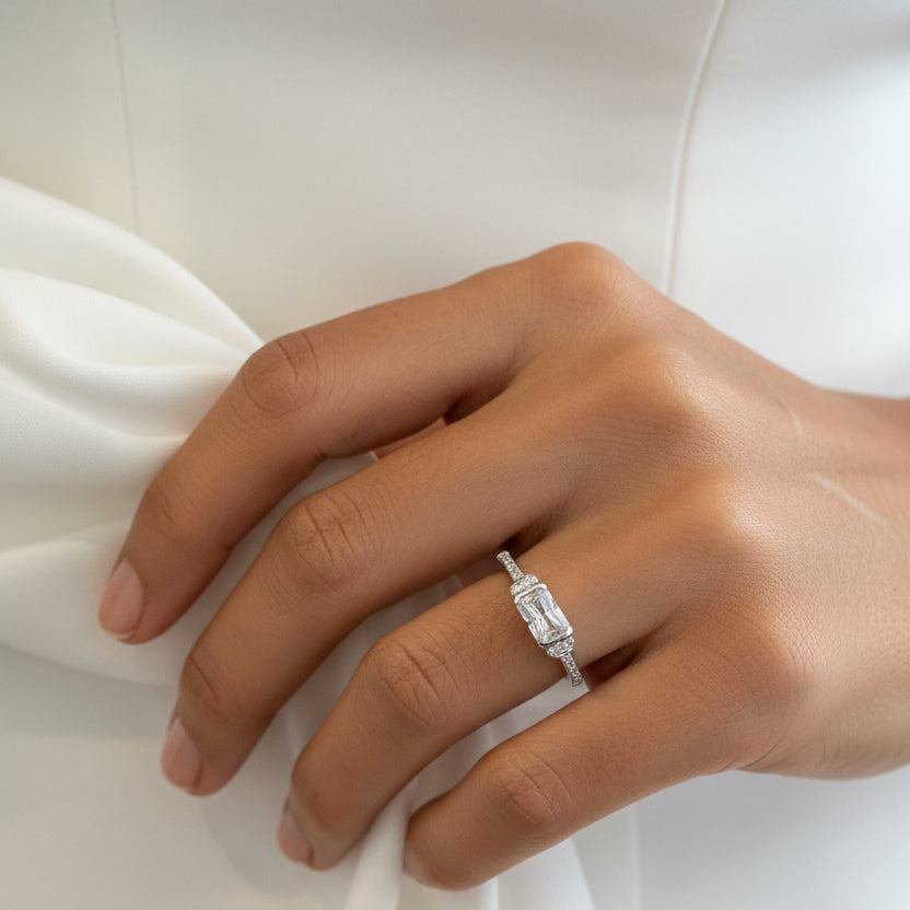 silver ring with a rectangular cluster of clear stones set on a band with small side stones