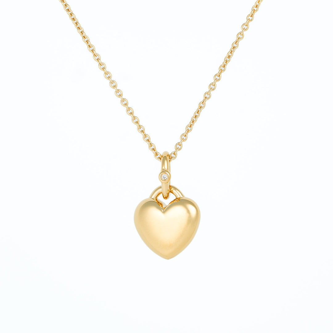 Gold heart-shaped pendant necklace on a white background