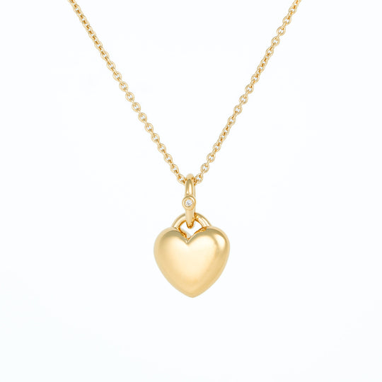Gold heart-shaped pendant necklace on a white background