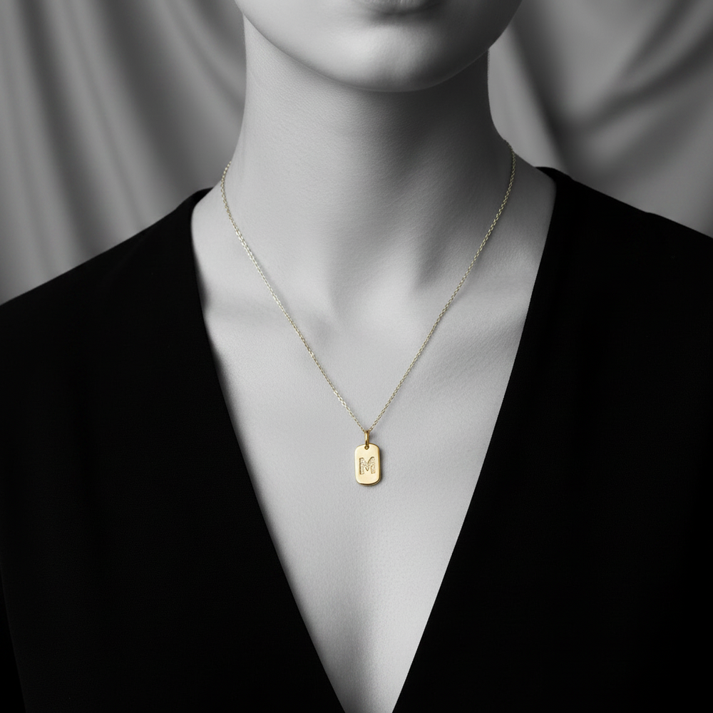 M initial tag pendant in yellow gold