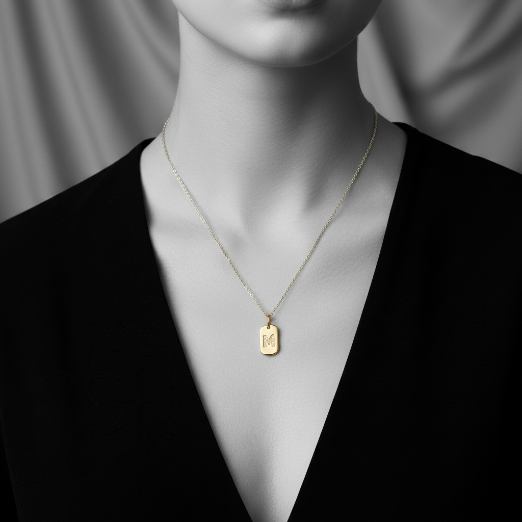 M initial tag pendant in yellow gold