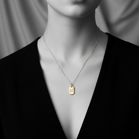 M initial tag pendant in yellow gold