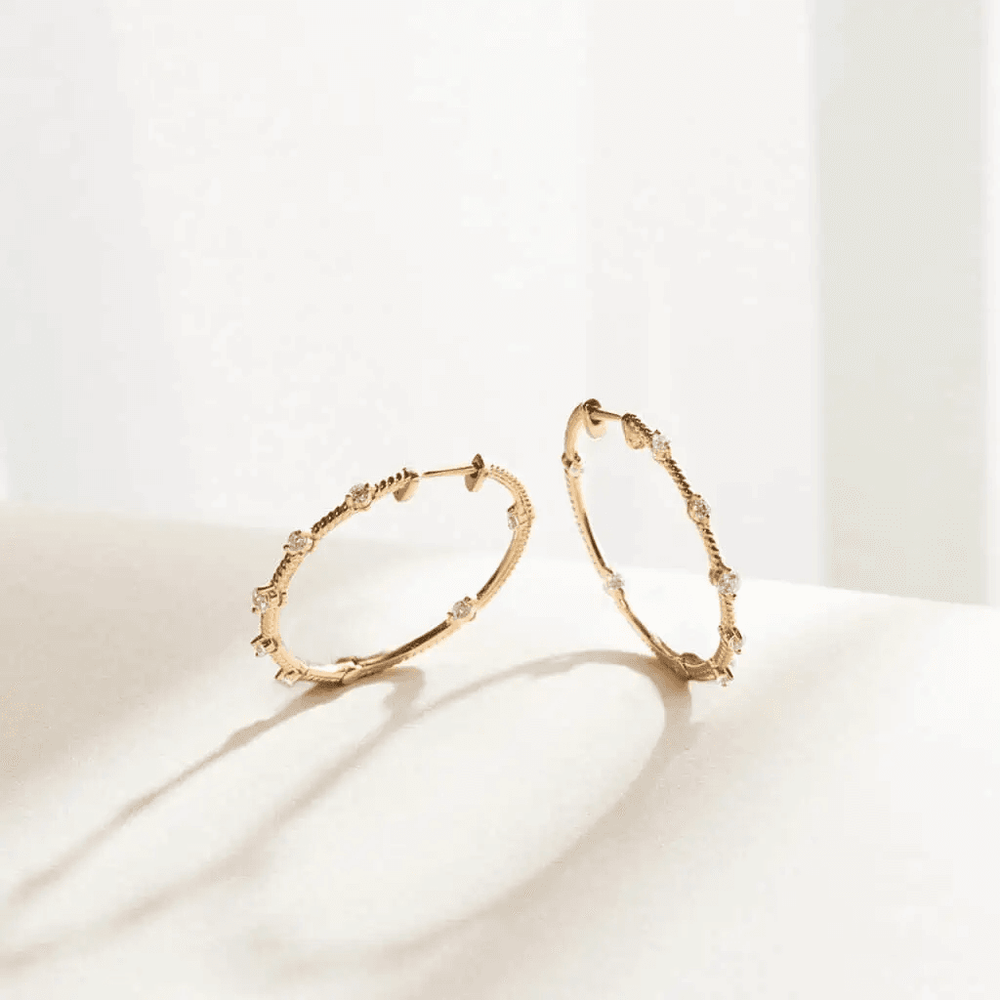 NAIMA Inside Out medium round twisted hoop earrings with eternity claw setting of round stones for women in 18K Yellow Gold vermeil