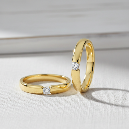 Two gold band rings with round stone for wedding