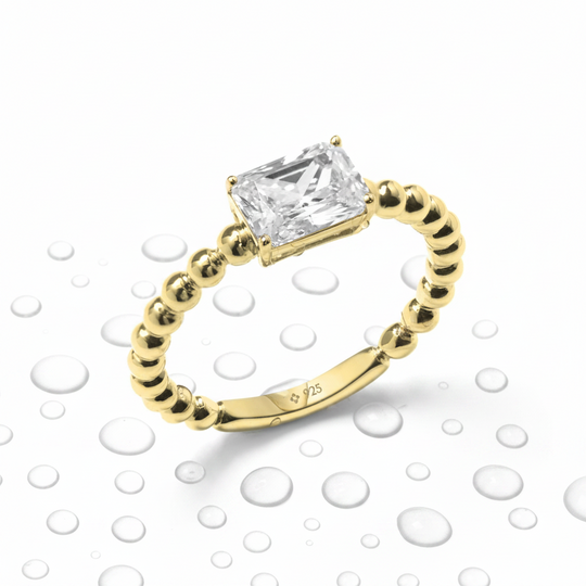 Yellow Gold Solitaire ring with Emerald Cut stone and beaded shank