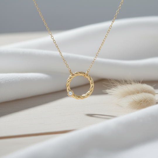 Gold necklace with a circular pendant twisted rope design